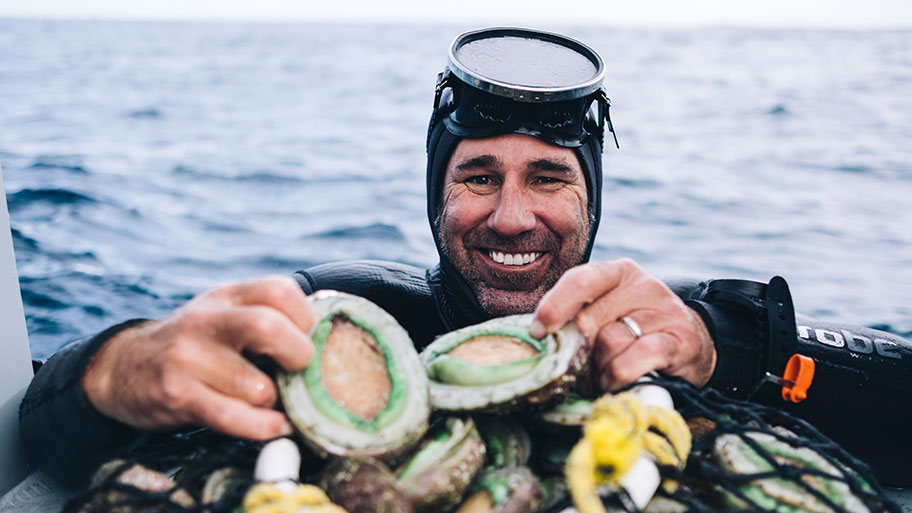 Diver holding greenlip abalone