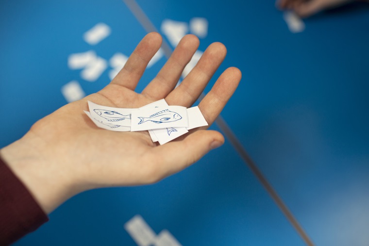 Image of a student's hand with paper fish