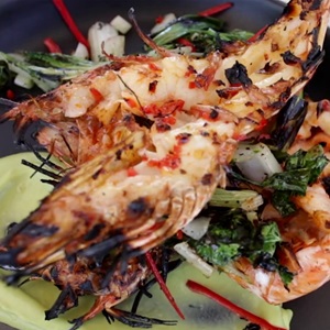 Wild chargrilled Skull Island Tiger Prawns with chilli and garlic oil, avocado mousse and charred greens
