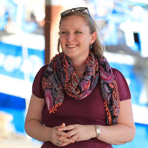 Woman wearing short-sleeved top and patterned scarf
