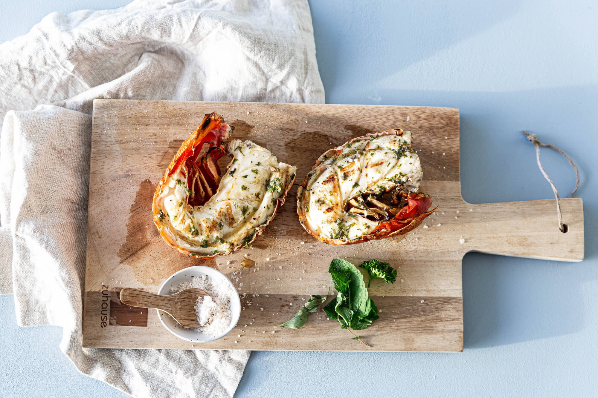 Wild sustainable BBQ rock lobster with salsa verde butter