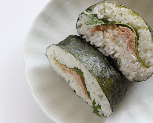 tuna and shiso rice ball cut in half on plate