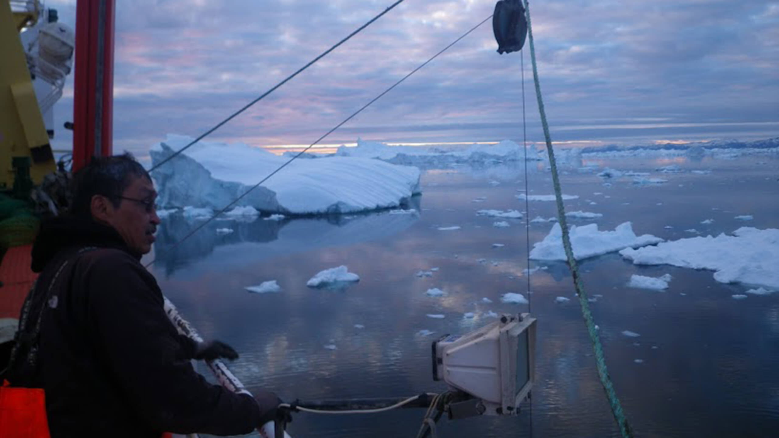 Man and icebergs in Greenland