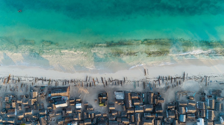 A shot of a shoreline crowded with boats.