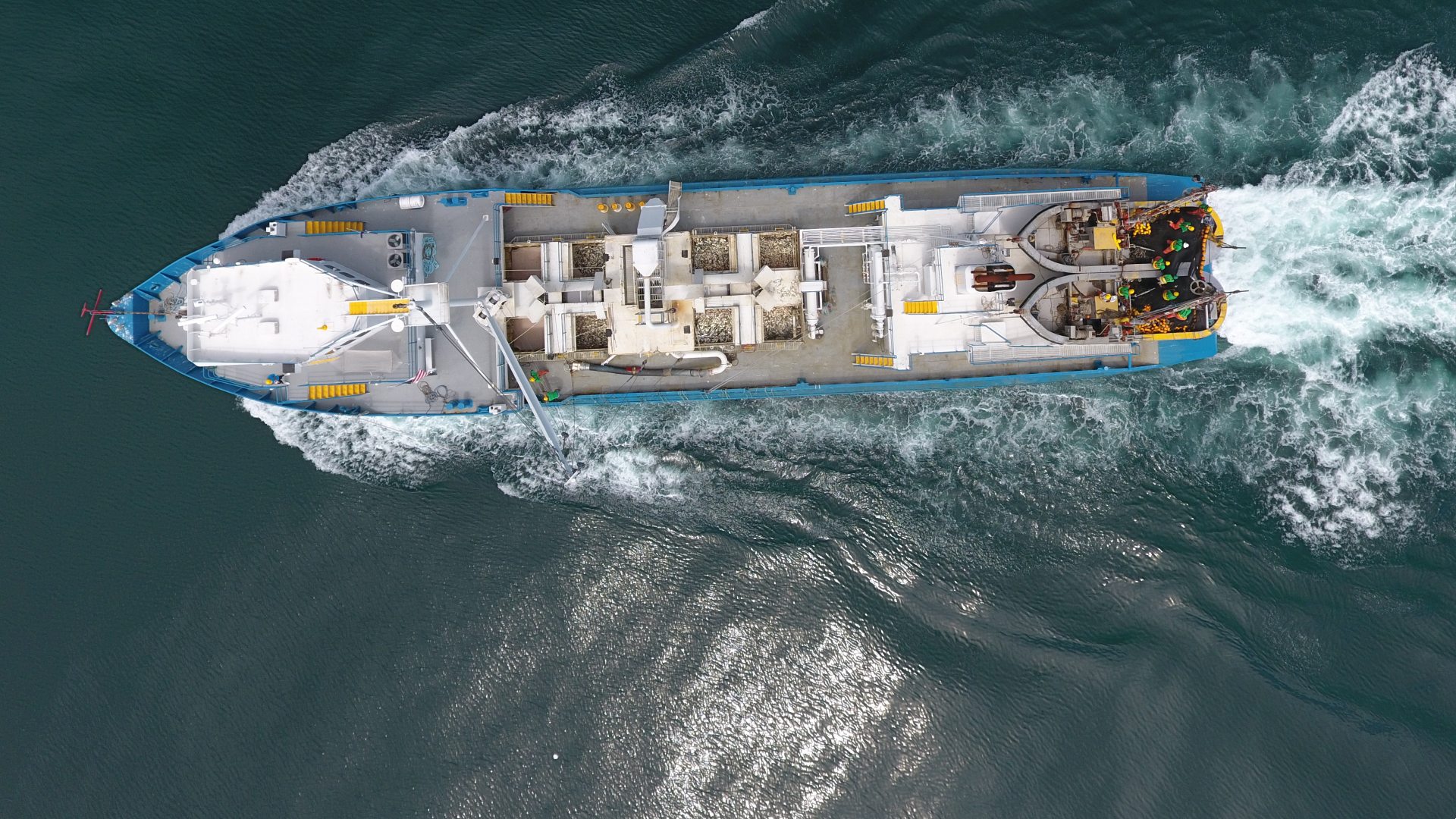 Large industrial fishing boat coming in with menhaden fish