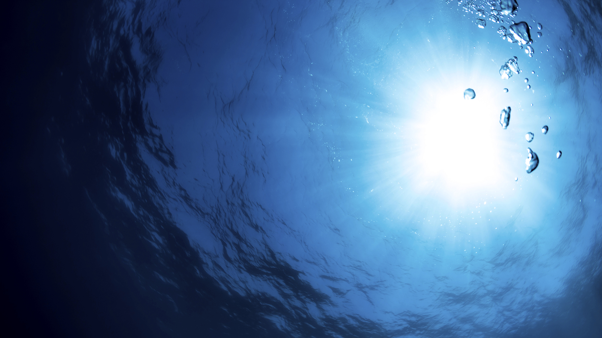 Bubbles underwater with sunlight