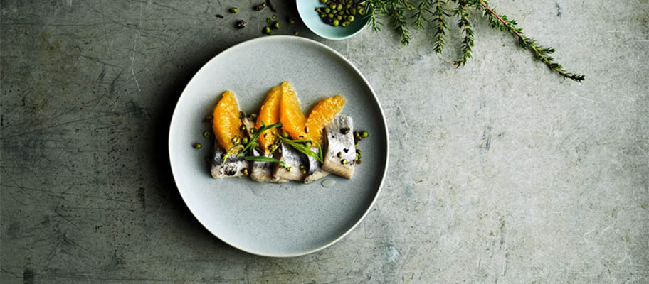 Cured and pickled herring on plate from above