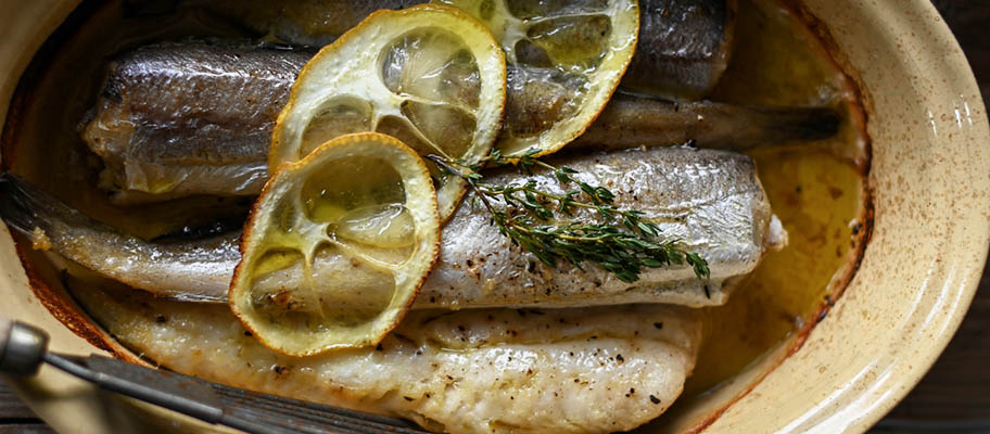 Hake fillets in dish with lemon slices