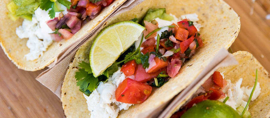 Aerial shot of taco shells with halibut and salad