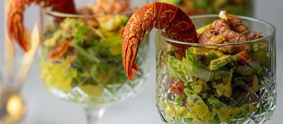 Lobster cocktail: two glasses filled with salad leaves and lobster tails