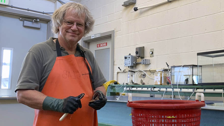 Man in orange apron in workshop