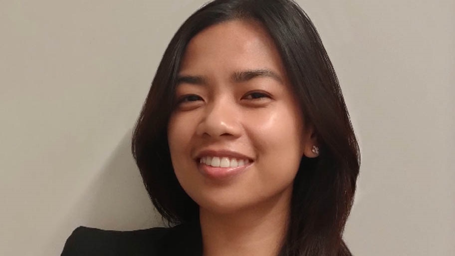 Headshot of woman with long hair and black jacket - Mishel Rañada