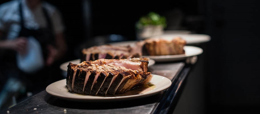 Cooked swordfish on plates ready for serving in restaurant.