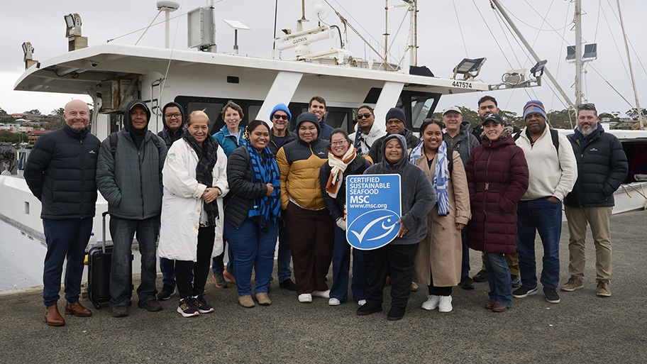 Pacific Island delegates from the UN FAO's Common Oceans Project standing with MSC label