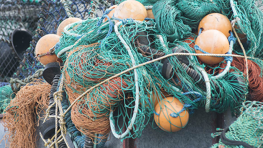 Close-up of fishing nets with marker floats, Cornwall, UK