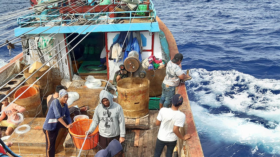 Indonesian tuna fishers organising longline gear and bait during fishing operations