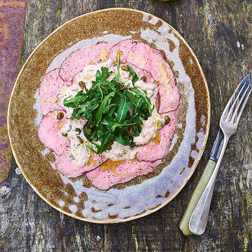 Serving suggestion for Vitello Tonato - on a plate with salad in the middle