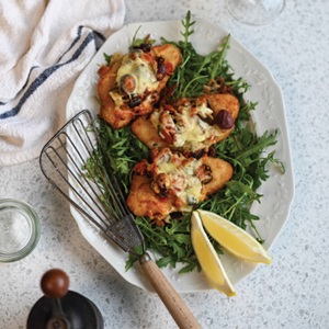 Crumbed hake caponata parmigiana