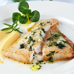 Pan fried hake with crisp sweet garlic