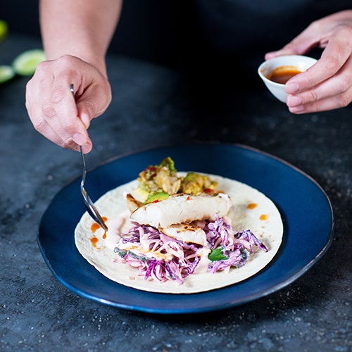 Wild hoki fish with chipotle coleslaw and harissa guacamole