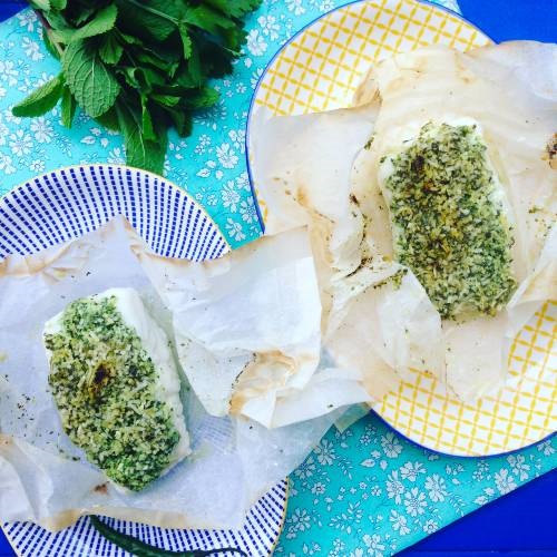 MSC-certified cod with a herb-crust of mint, coconut and coriander on a blue striped plate