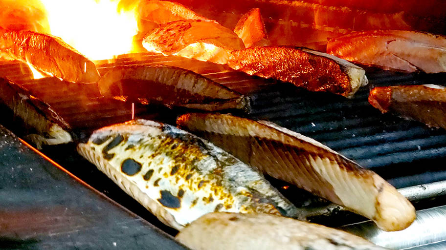 Fresh tuna on grill, with flames behind