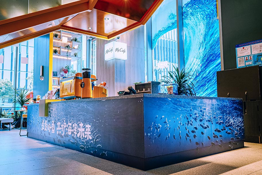 Interior of McDonald's restaurant in China with ocean themed counter and backdrop