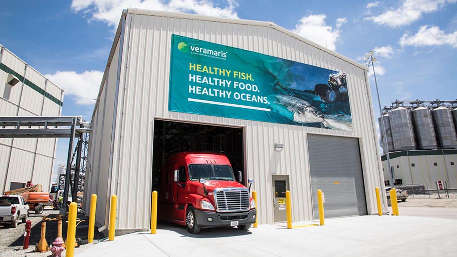 Red truck emerging from factory