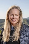 Birgit Cameron Woman with long hair in gilet in front of hills