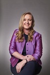 Darian McBain Portrait of seated woman in purple jacket: Darian McBain
