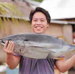 Portrait of Anthony Alvin holding large tuna
