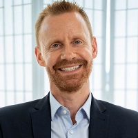 Headshot of man with beard in shirt and suit jacket: Chris Shearlock of Princes UK