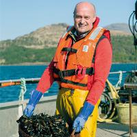 Man holding MSC certified mussels on board  boat as part of Lidl campaign