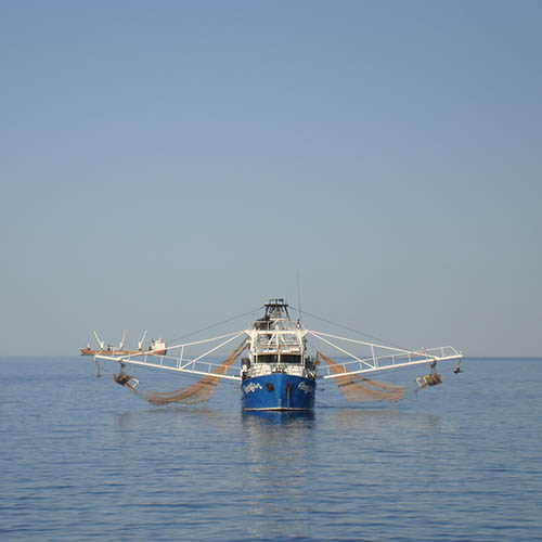 Ship at sea with nets cast on both sides