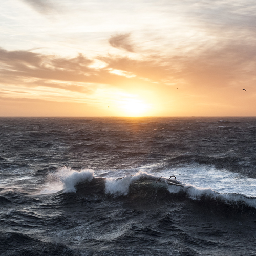 Sunset in the Southern Atlantic with a crashing wave