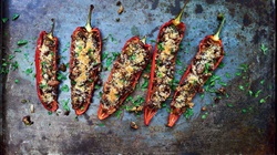 Tuna and olive stuffed romano peppers on a board