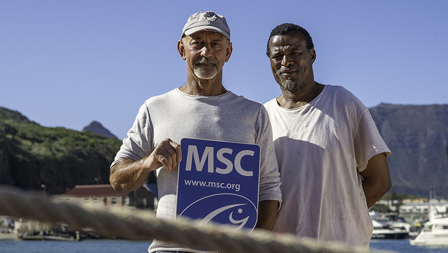 Southern African Sustainable Tuna Association albacore tuna pole and line fishery (SATSUNA) members with MSC label board Two fishers in South Africa holding MSC label board