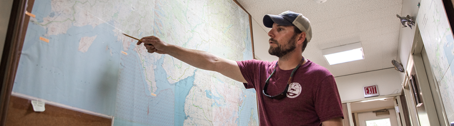 Man pointing at map of Alaska