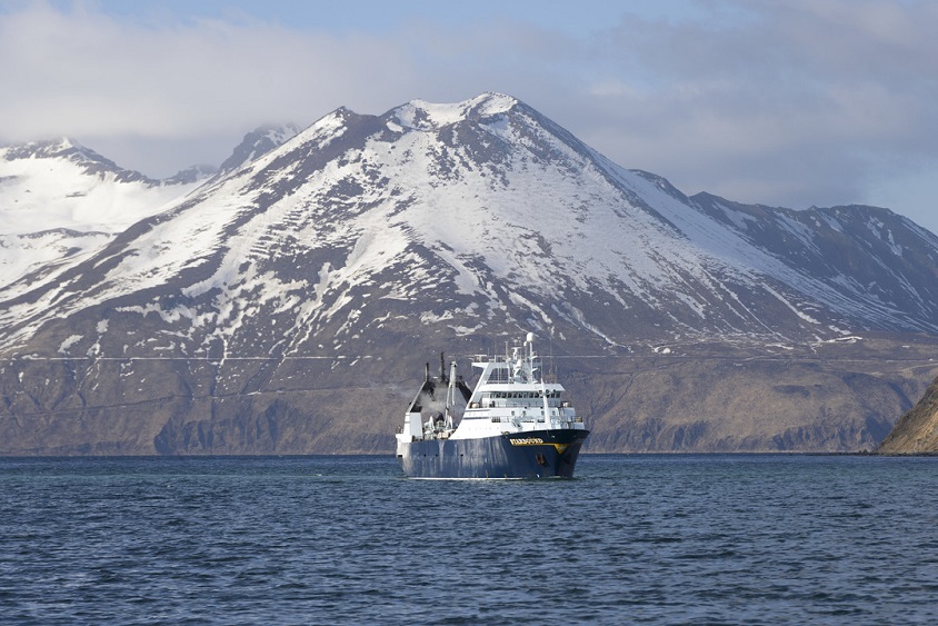 CP Starbound, large fishing vessel, in Alaska with mountains in the background