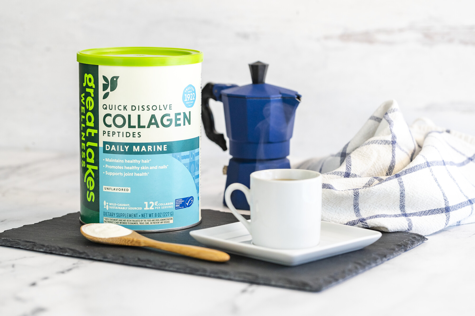 Tray with container of marine collagen and a cup of coffee.