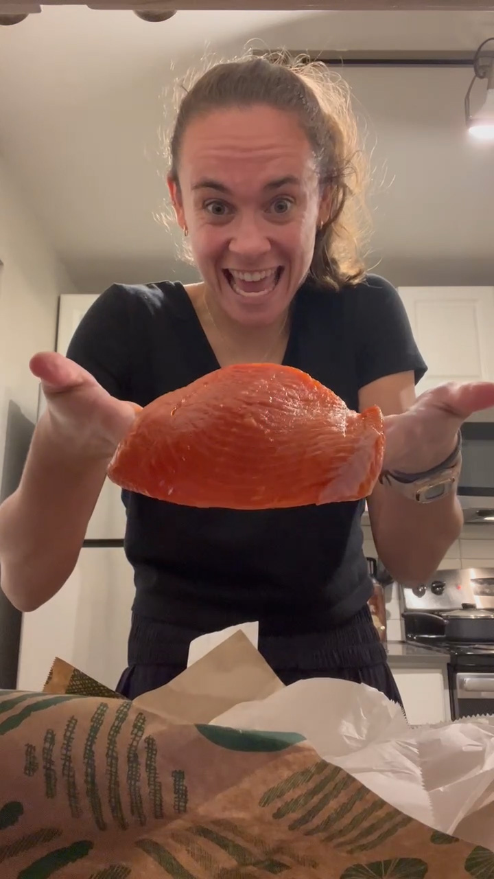 Woman showing a fillet of salmon to the camera