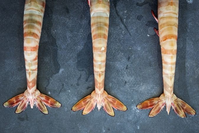 Prawn tails on a dark countertop