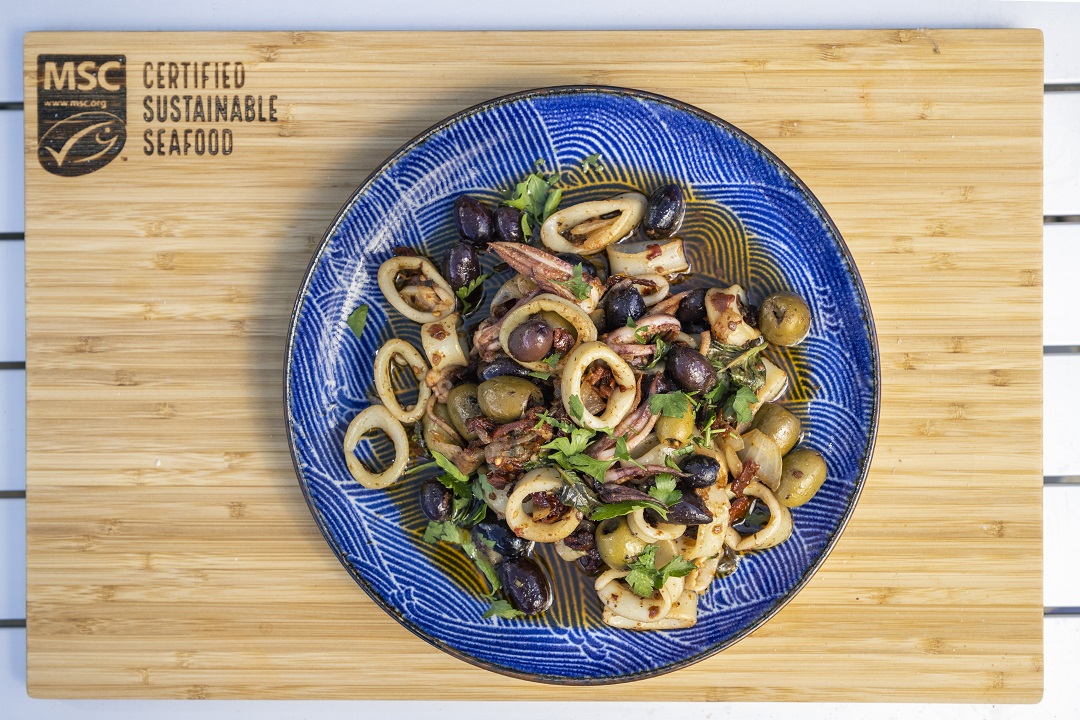 Squid puttanesca with olives and greens