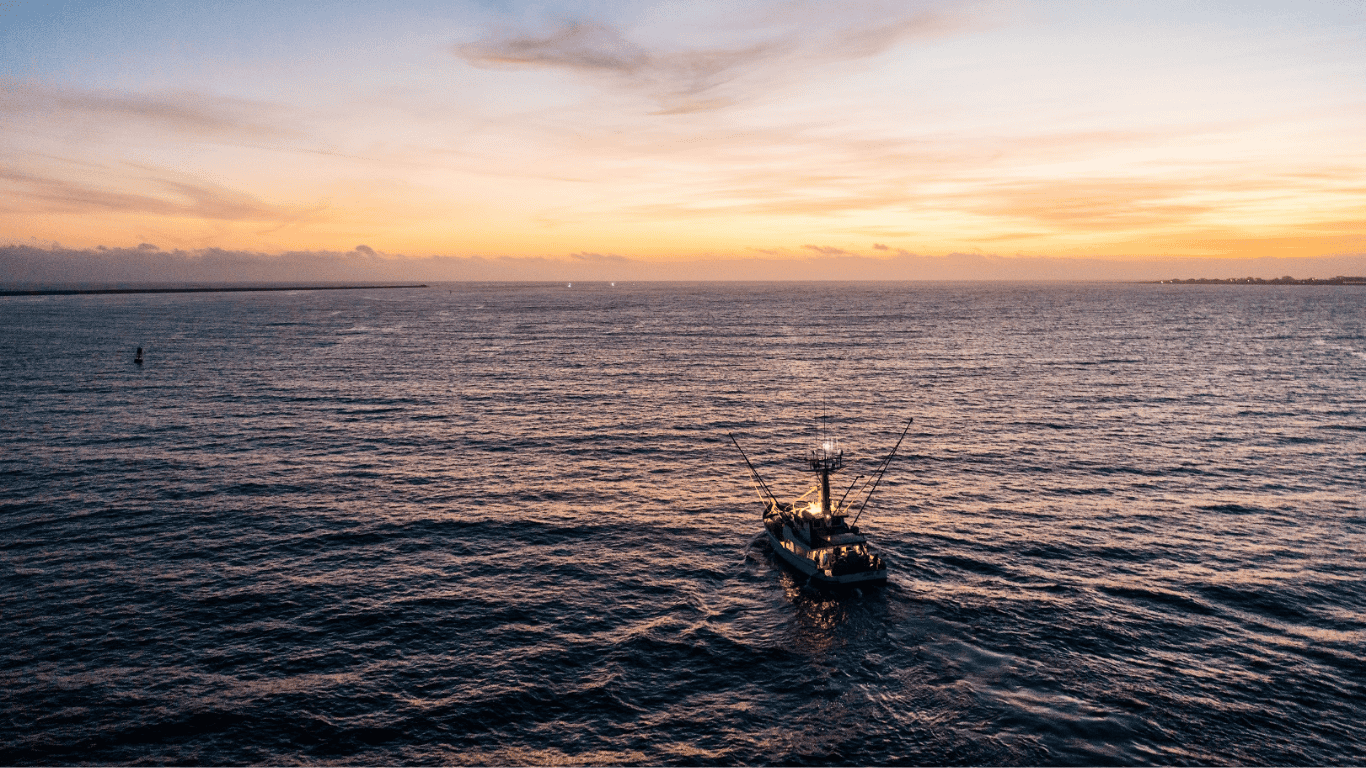 Tuna fishing boat on calm waters at sunset