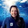 Emily Wyatt Headshot of woman in front of an underwater background