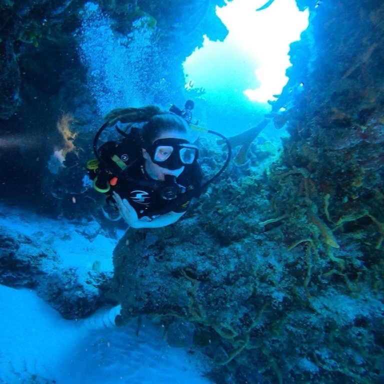 MSC staff member Megan Atcheson SCUBA diving among coral reefs