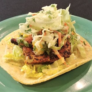 Cajun halibut tacos with chipotle aioli, mango salsa and jalapeno buttermilk coleslaw