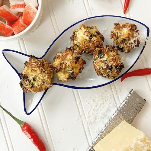 Crab stuffed mushrooms on a white fish shaped plate