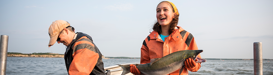 Fisherman holding salmon