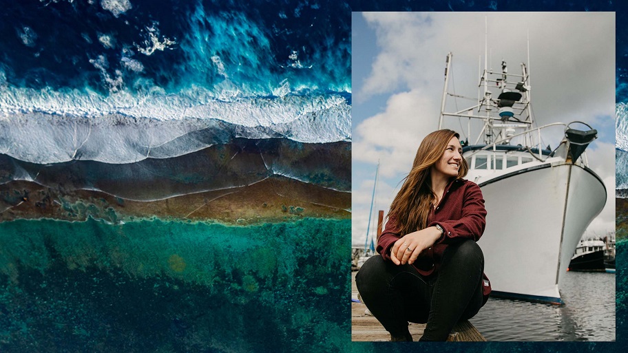 Female fisherman poses in front of a fishing boat
